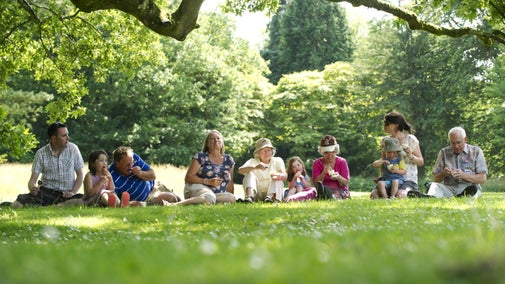 Different generations enjoy a picnic on the grass at Dyffryn Gardens, South Glamorgan